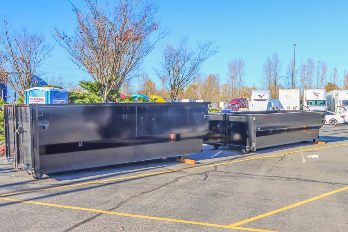 Professional dumpster rental service with roll-off container on residential driveway in Coal City